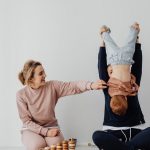 Mother and child enjoying playful time indoors with educational toys.