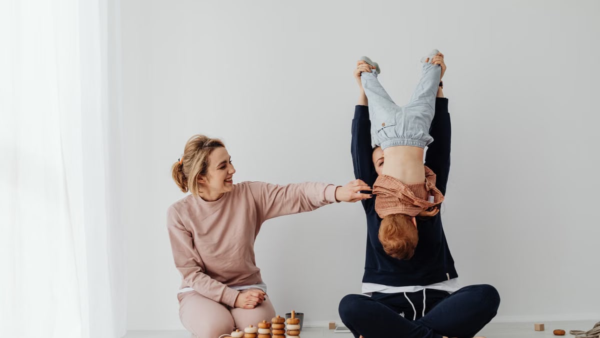 Mother and child enjoying playful time indoors with educational toys.
